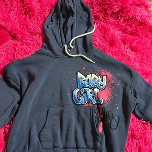 This is a blue crop top hoodie with graphic lettering.